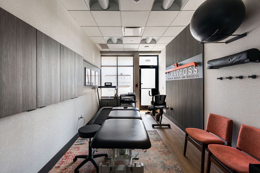 Albatross Physical Therapy Naperville — full treatment room view showing therapy equipment, treadmill, and stationary bike