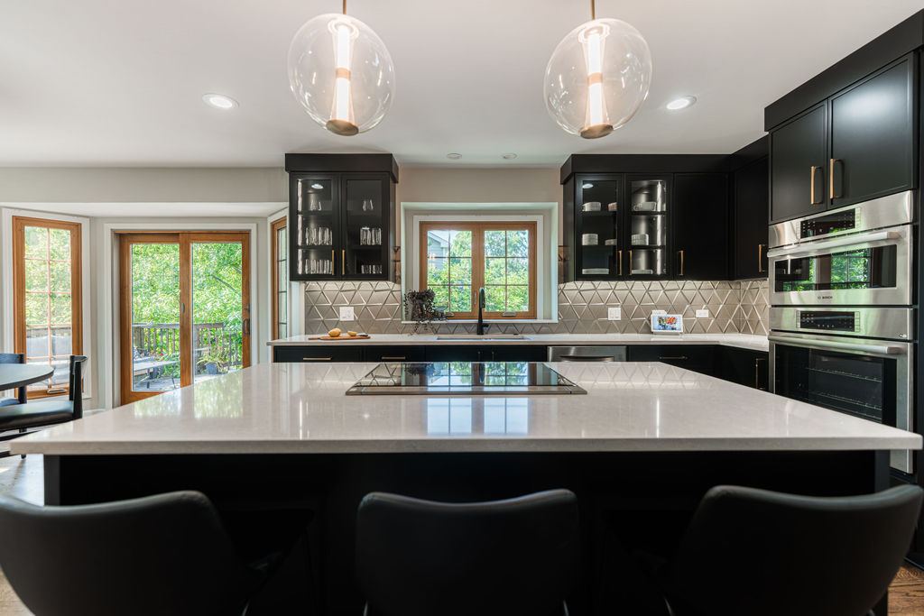 Alyssa Naperville kitchen — full view of black shaker cabinetry with brushed gold hardware and geometric diamond tile backsplash