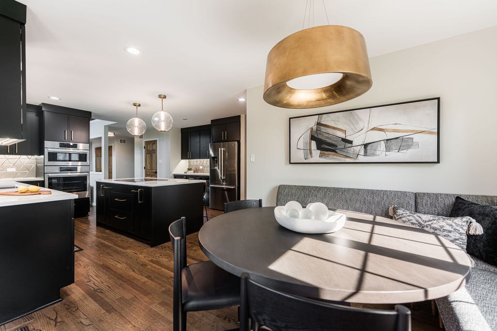 Alyssa Naperville kitchen — island overview with globe pendant lighting and breakfast nook with banquette seating