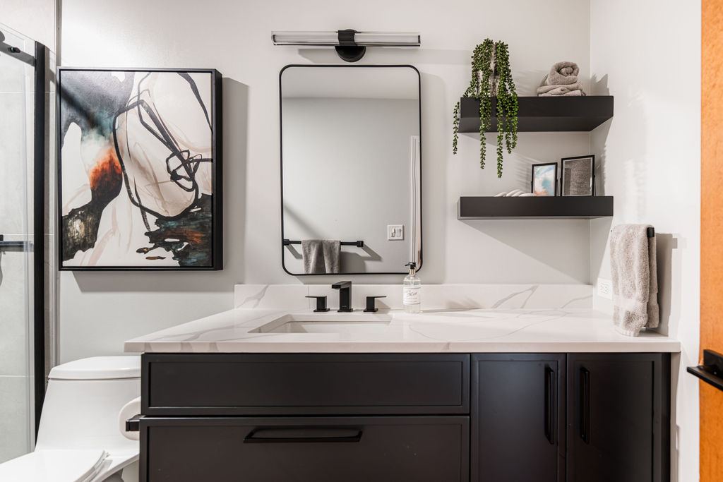 Alyssa Naperville bathroom — matte black vanity detail with white quartz, black hardware, and modern black-framed mirror