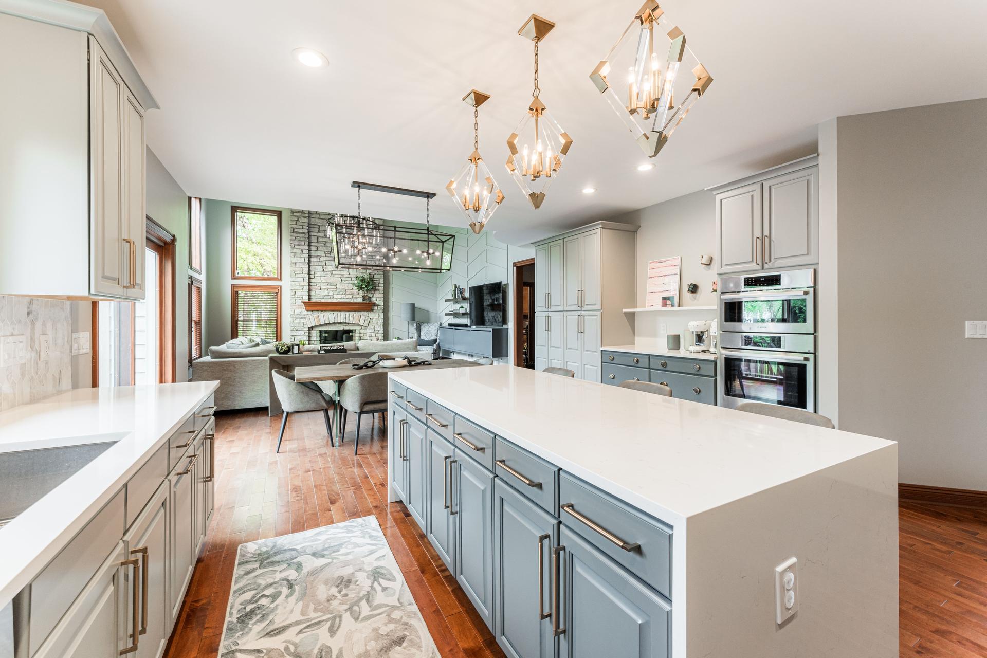 Kitchen remodel — two-tone cabinetry, extended quartz island, Bosch appliances — Bealer Geneva IL