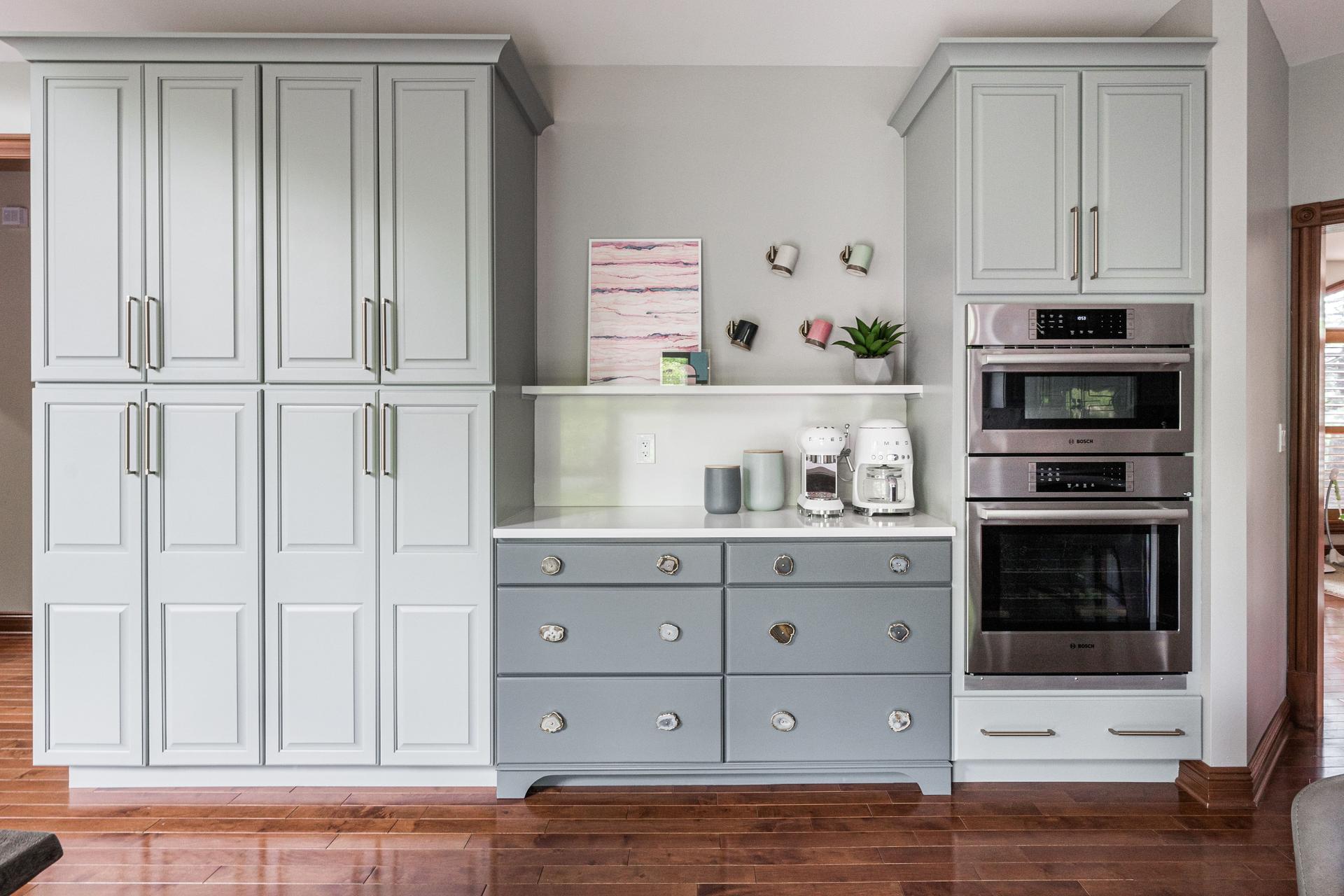 Pantry wall — gray cabinetry, sage accent drawers with agate stone knobs, Bosch double ovens, coffee station niche — Bealer Geneva IL