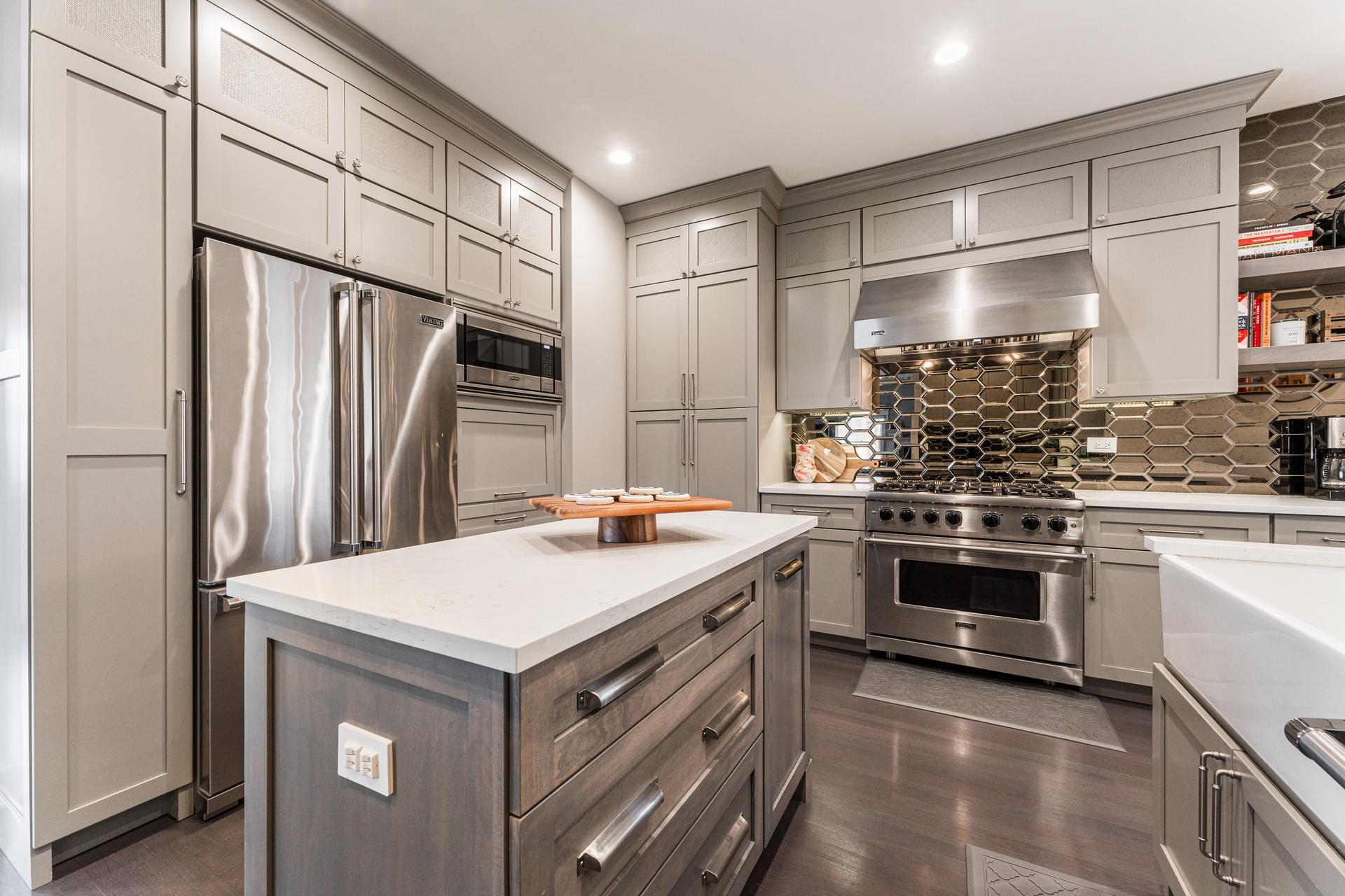 Kitchen island, Viking range, and floor-to-ceiling gray cabinetry — bronze mirrored hex tile backsplash — Dillman kitchen remodel Plainfield IL