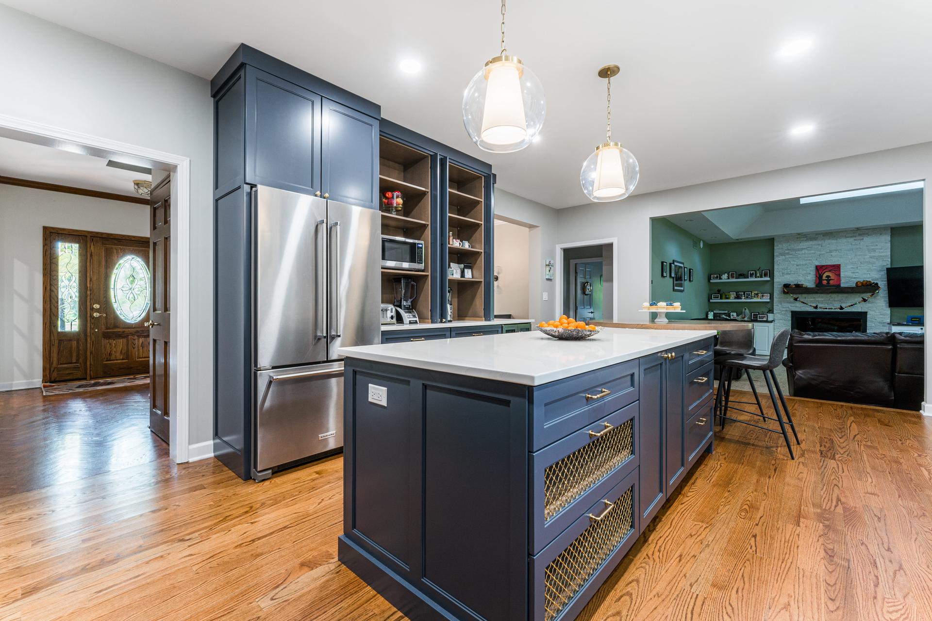Island and pantry wall — navy island with brass mesh inserts, KitchenAid refrigerator, open appliance garage — Eastcliff Shorewood IL