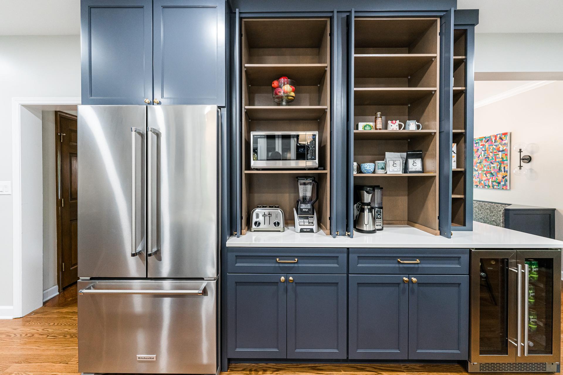 Open appliance pantry tower with built-in appliance garage, wine cooler, and KitchenAid refrigerator — Eastcliff Shorewood
