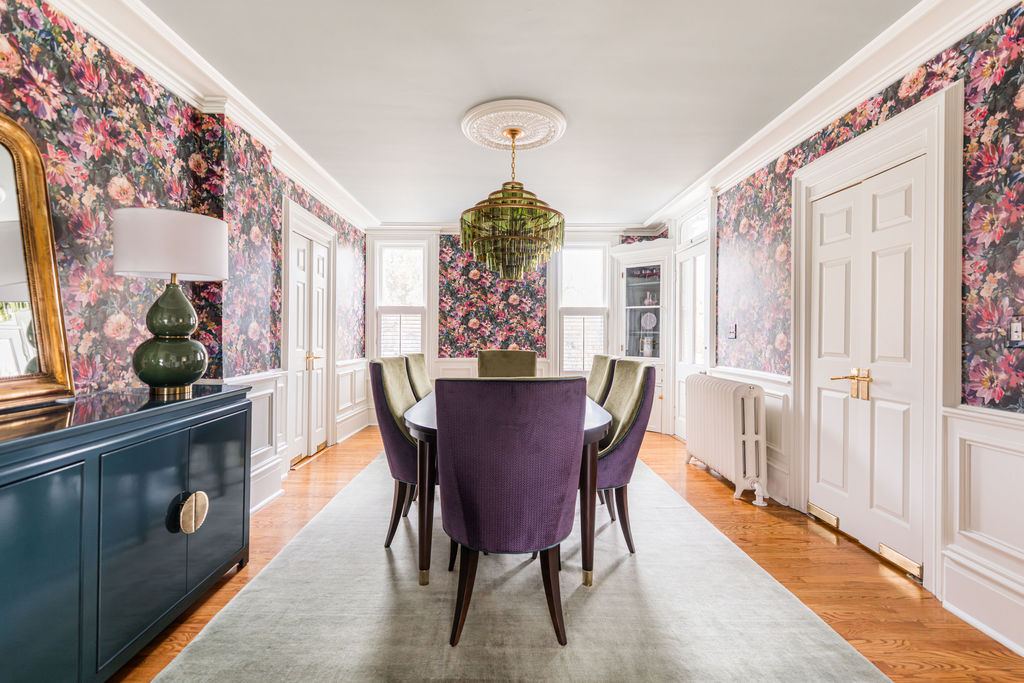Fulton Geneva dining room — dramatic floral wallpaper with wainscoting, dark dining table, and layered lighting in historic home renovation