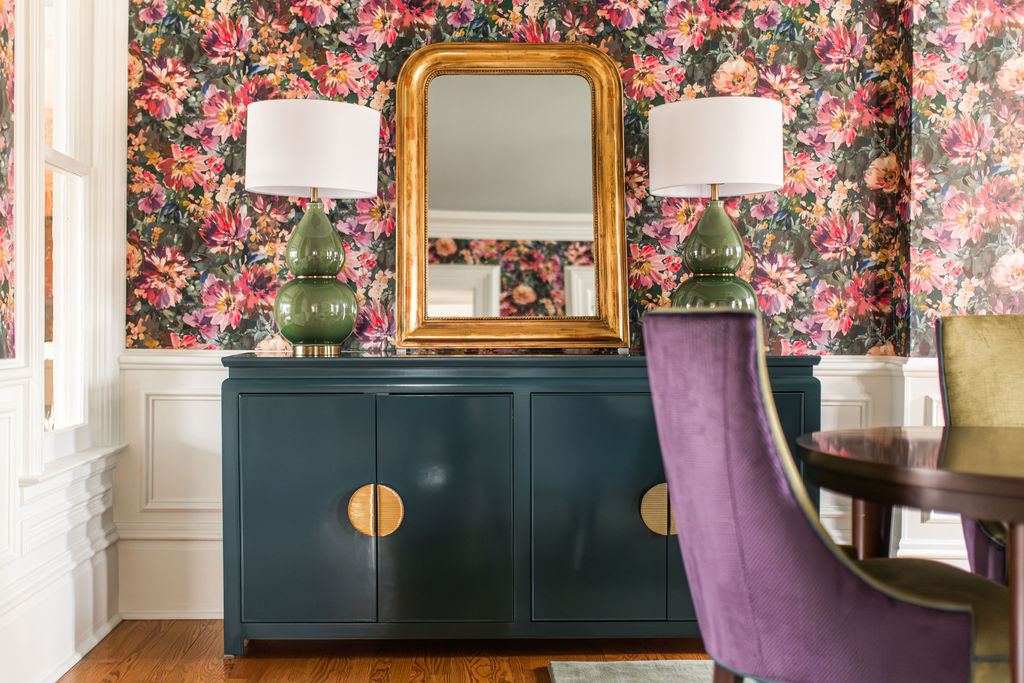 Fulton Geneva — dining room sideboard detail with gold mirror, green ceramic lamps, and full-coverage floral wallpaper