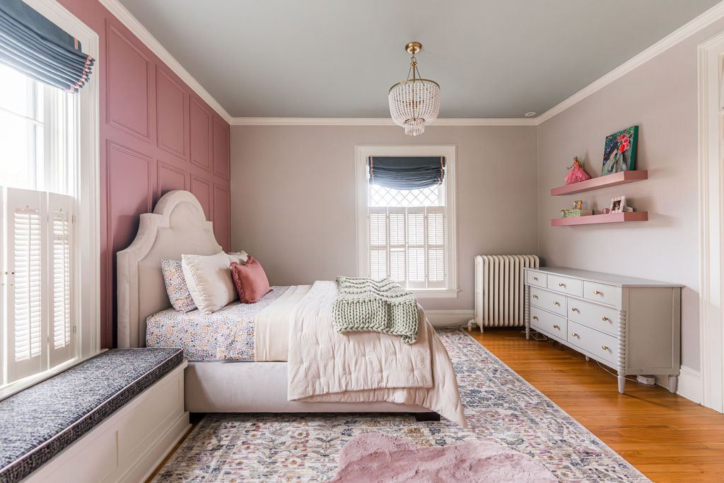 Fulton Geneva girl's bedroom — second view showing bay windows, built-in storage, upholstered arched headboard, and historic millwork