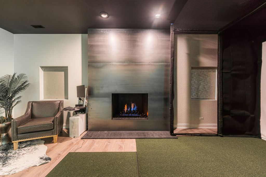 Hickory St. Charles — lounge and seating area with green shiplap accent wall and neon sign