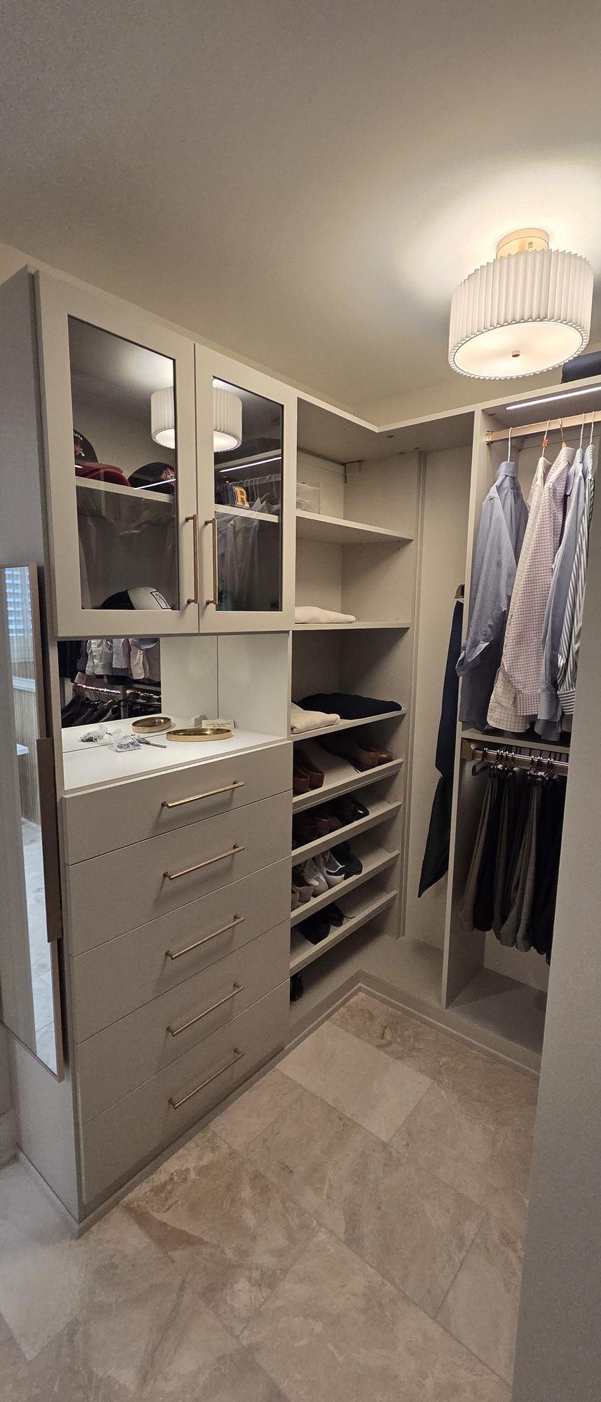 Park Ridge walk-in closet — custom drawer bank with brass pulls, glass-front display cabinets and shoe shelving