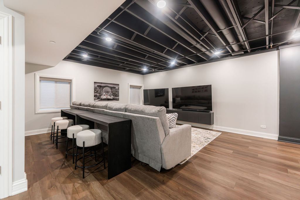 Yorkshire Oakbrook — open lounge overview showing LVP flooring, bar area and media zone