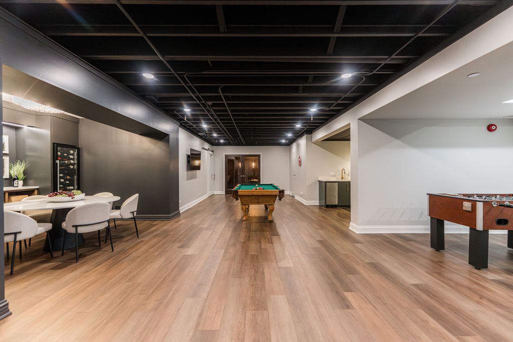 Yorkshire Oakbrook — media lounge with grey sectional and dark floating TV console