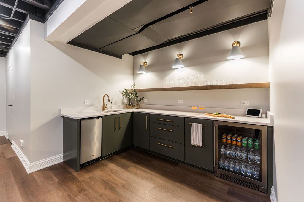 Yorkshire Oakbrook — bar detail with brass sconces, floating wood shelf, and glassware display