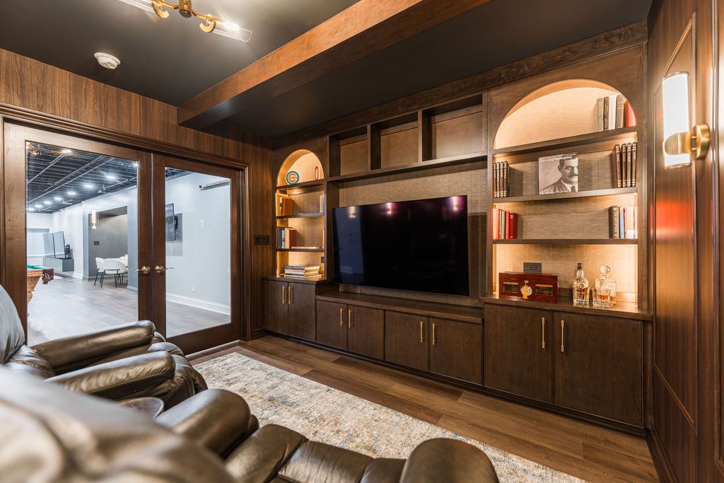 Yorkshire Oakbrook — library entertainment wall with arched niches and brass accent lighting